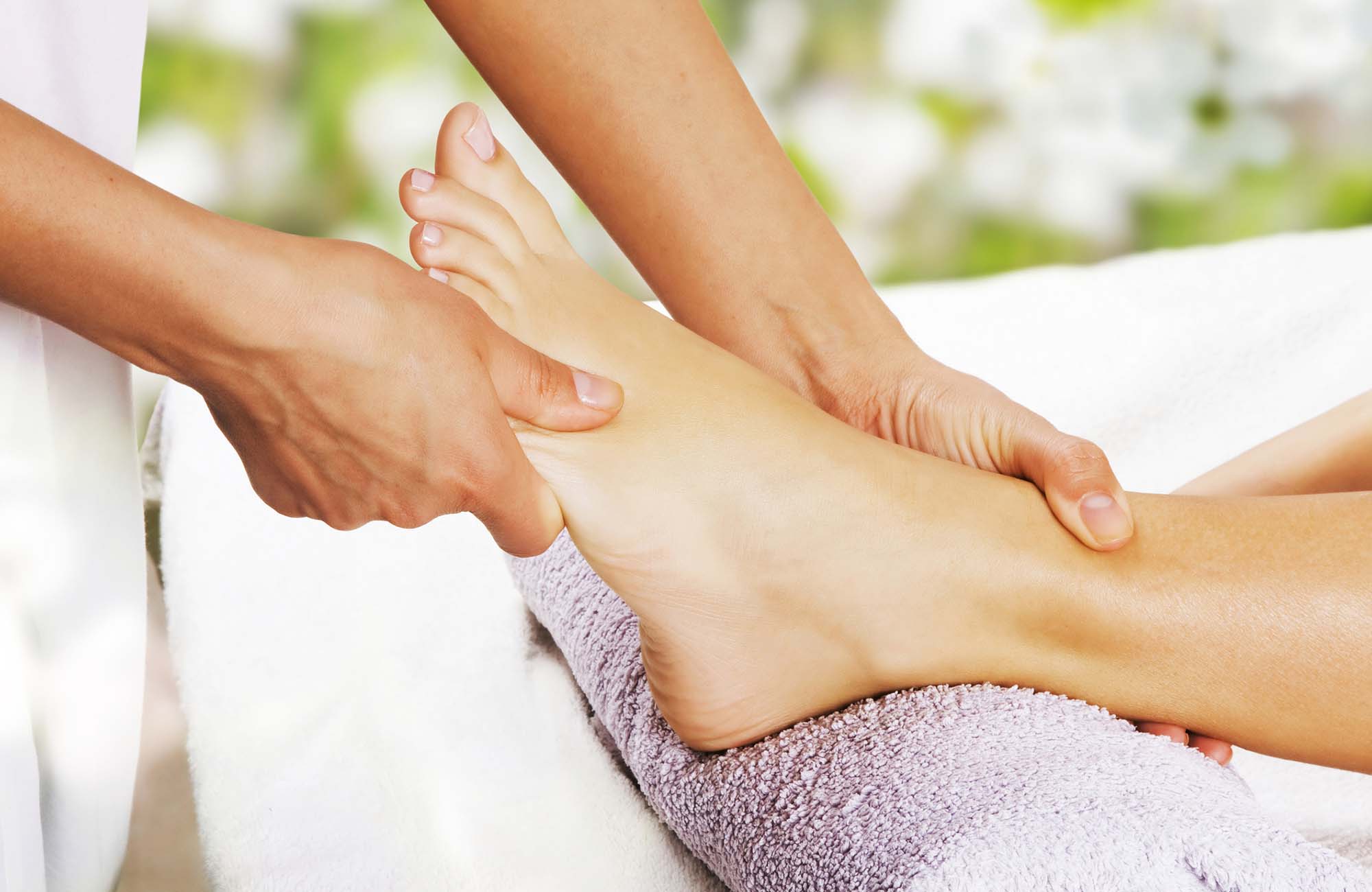 Foot massage in the spa salon in the garden